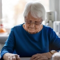 Senior woman filling out financial statements