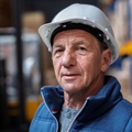 Mature warehouse worker with helmet
