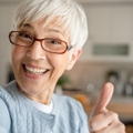 An older woman with a thumbs up