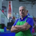Older supermarket manager with crossed arms