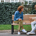 Older couple playing chess on bench