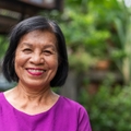 Woman in her late 60s looking at camera with a large smile