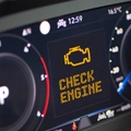 Car dashboard with engine light on