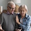 Concerned retired couple on couch 
