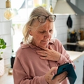 Woman with smartphone looking concerned