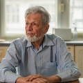 Contemplating older man in kitchen 
