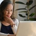 Older woman at home on laptop