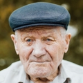 Portrait of an elderly man wearing a cap