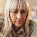 Older woman looking down sad