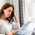 Concerned mature woman looking at paper