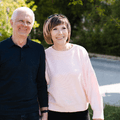 Couple in their 60s walking on the sidewalk in neighborhood