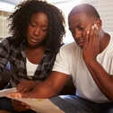 Stressed couple looking at paperwork