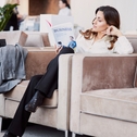Woman reading book in hotel lounge