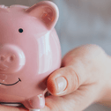 Someone holding a piggy bank