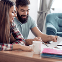 A man and woman go over their finances together.