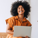 smiling person on laptop