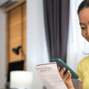 person paying bills on phone
