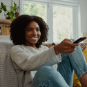 person with remote control in hand