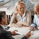 Financial advisor sitting with older couple