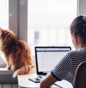 Woman working at desk with cat