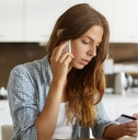 woman calling to pay bills with credit card