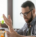Confused man checking phone