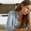 Stressed woman looking at bills