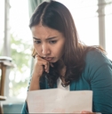 Worried woman looking at paperwork