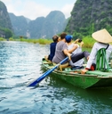 Travelers riding boat down river