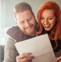 happy couple looking at paperwork