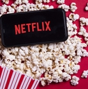 Netflix app on phone and popcorn