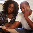 Stressed couple looking at paperwork