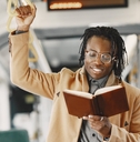 man reading book on train