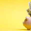 Piggy bank isolated on yellow background.