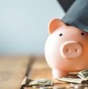 piggy bank wearing graduation cap