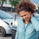 Woman suffering whiplash after bad cars pile up