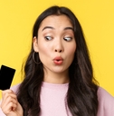 girl looking amused at credit card