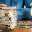 Jar filled with coins labeled retirement 