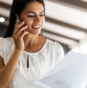 Woman on phone reading paperwork