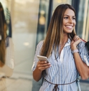 Woman shopping with phone in hand