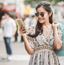 Woman carrying shopping bags and looking at her phone