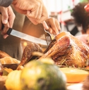 Person carving the Thanksgiving turkey