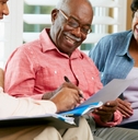 Senior couple reviewing documents with a salesperson