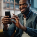 Man smiling and looking at phone