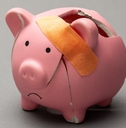 Broken piggy bank with band-aid