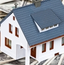 Model house sitting on money