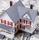 Model house sitting on money
