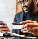 man with credit card and phone