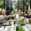 Happy retired friends eating together
