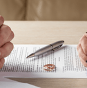 couple signing divorce paperwork